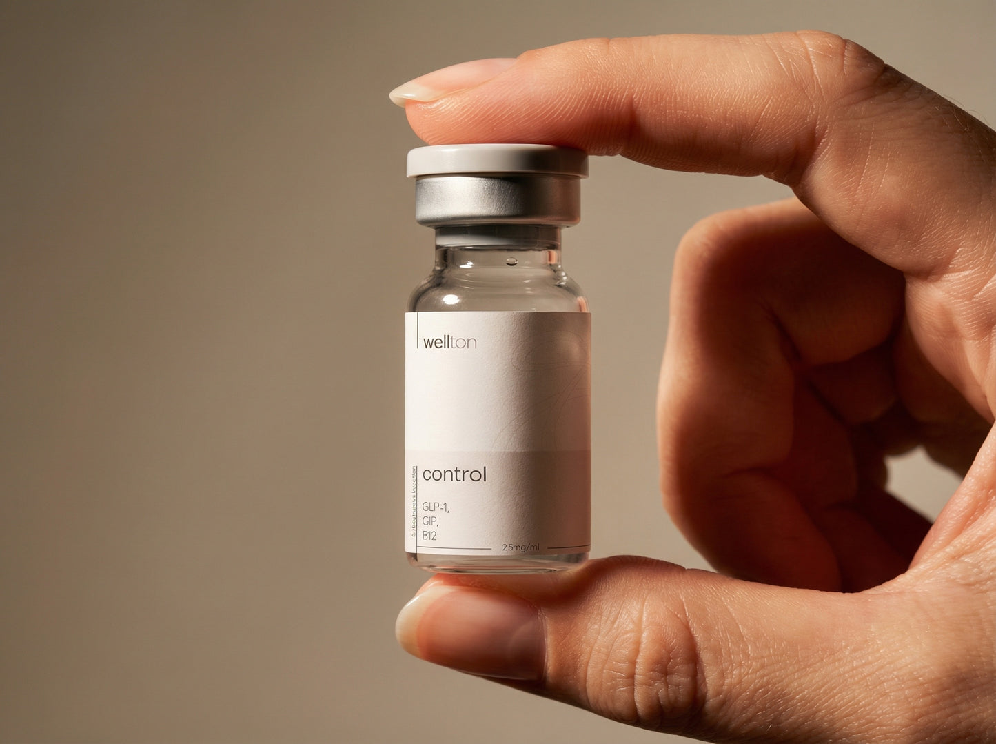 Hand holding a small glass vial labeled 'control' with a beige background